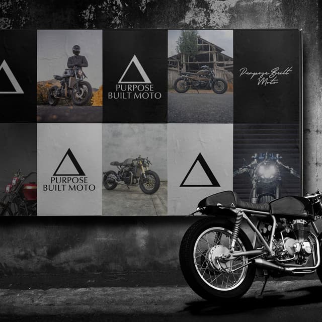 A cafe racer motorcycle stands in front of a wall of framed Purpose Built Moto posters.