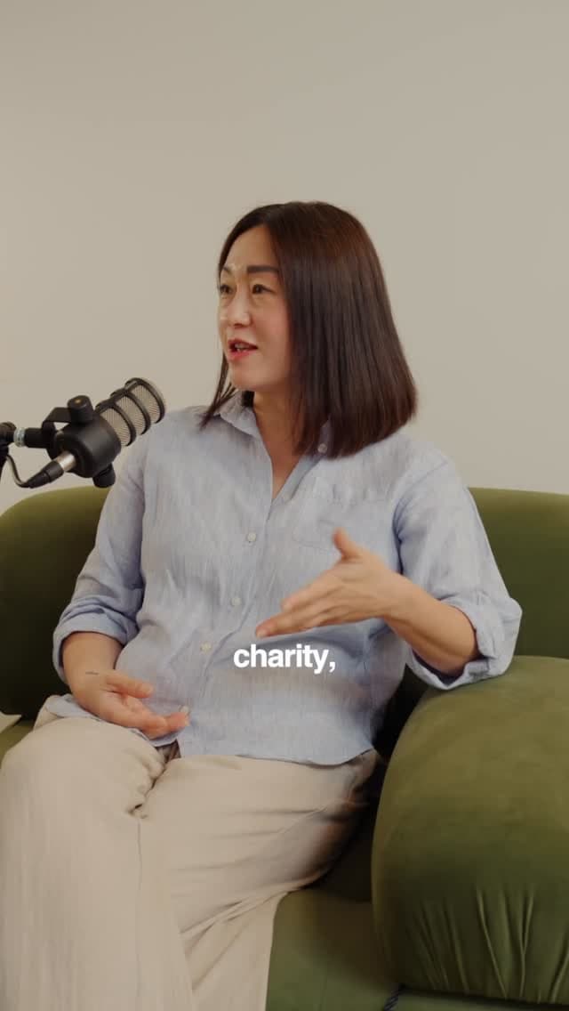 A guest speaks about charity on a green sofa during a podcast style video interview.