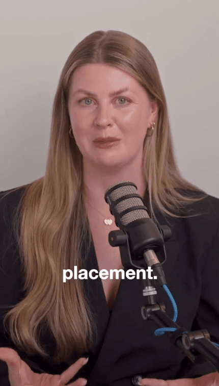 A woman speaks into a podcast microphone with the word placement captioned on screen.