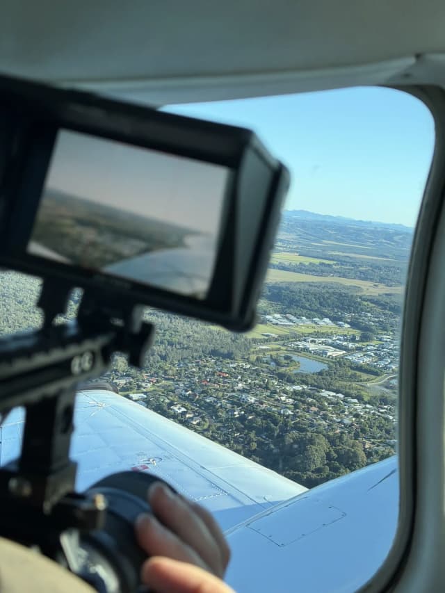 An aerial camera monitor shows farmland below during a flight over a Providore Global property.
