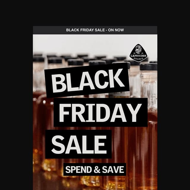 A Black Friday sale ad for Capricorn Distilling Co features bold stacked text over blurred spirit bottles.