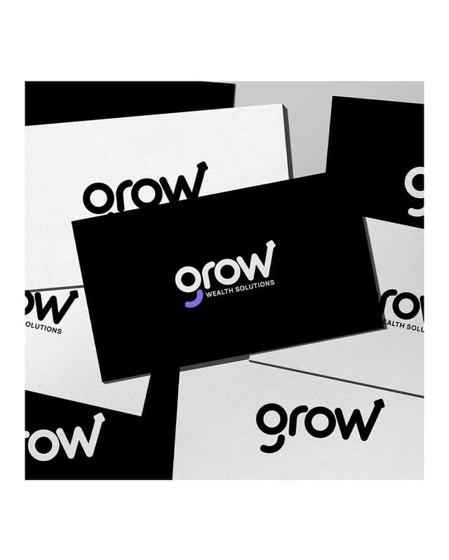 Business card mockups scatter across a surface, each printed with the Grow Wealth Solutions logo.