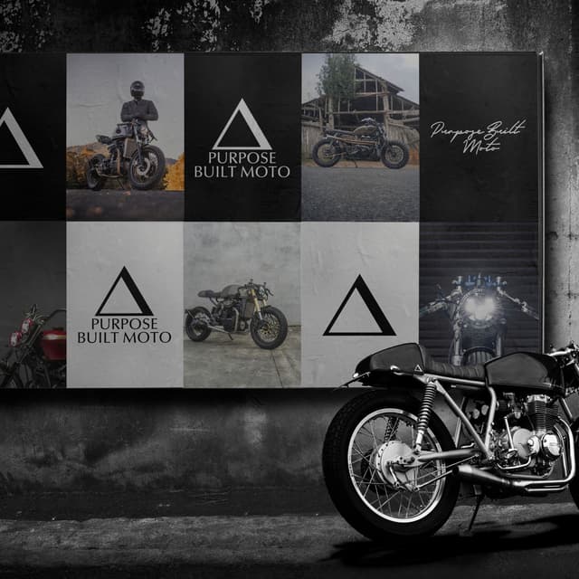 A Purpose Built Moto poster wall featuring custom motorcycle photography stands next to a black cafe racer motorcycle.