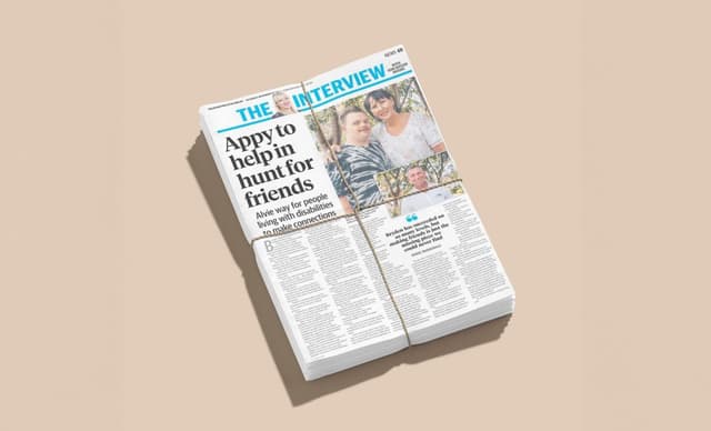 A rolled newspaper shows a feature headlined 'Appy to help in hunt for friends' about an app for people with disabilities.