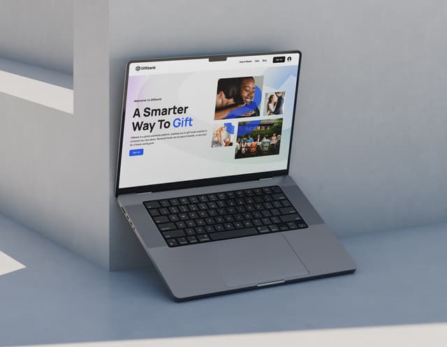 A laptop screen shows the Giftbank website homepage with the headline A Smarter Way To Gift.