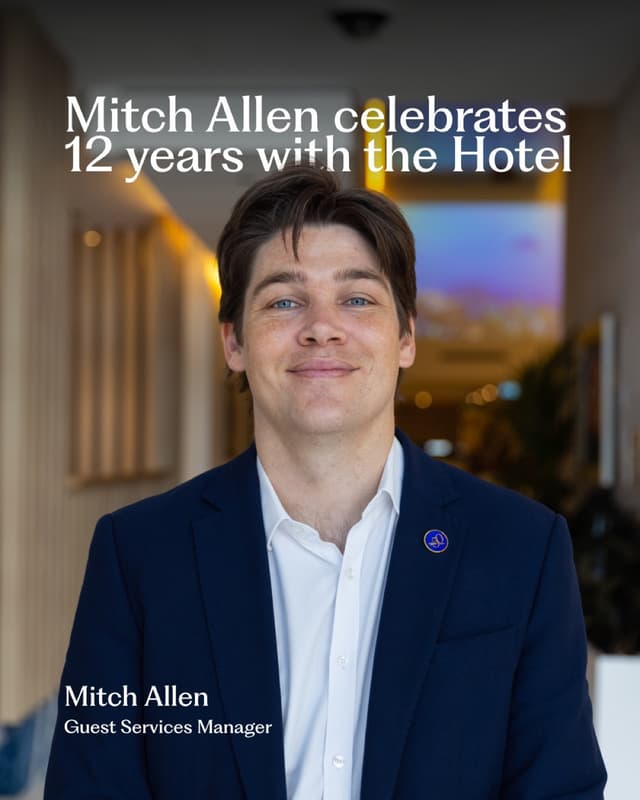 Mitch Allen, a Hilton Surfers Paradise Guest Services Manager, poses in a hotel corridor for an anniversary feature.