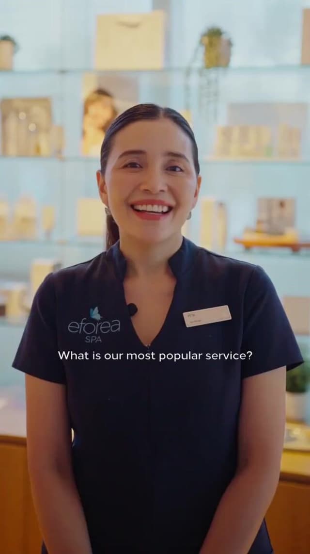 A Hilton Surfers Paradise eforea Spa staff member smiles while answering a question about the spa's most popular service.