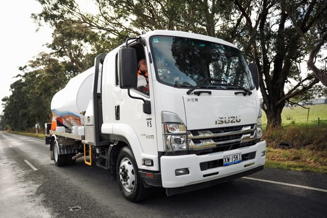 A Padthaway Resources tanker driving a country road under trees.