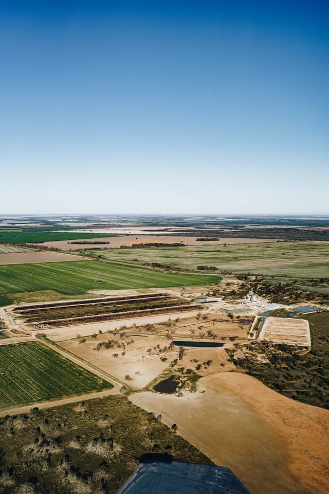 An aerial view of a Providore Global feedlot and farmland stretching toward the horizon.