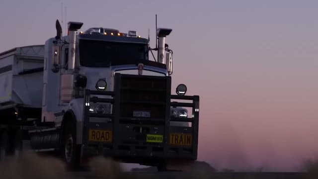 The ROADBOSS website's features section, including a truck driving through fog, shown on a desktop monitor.