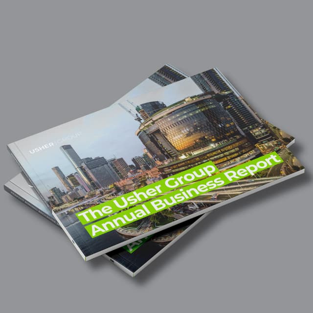 Two mockup covers of The Usher Group Annual Business Report feature a city skyline at dusk.