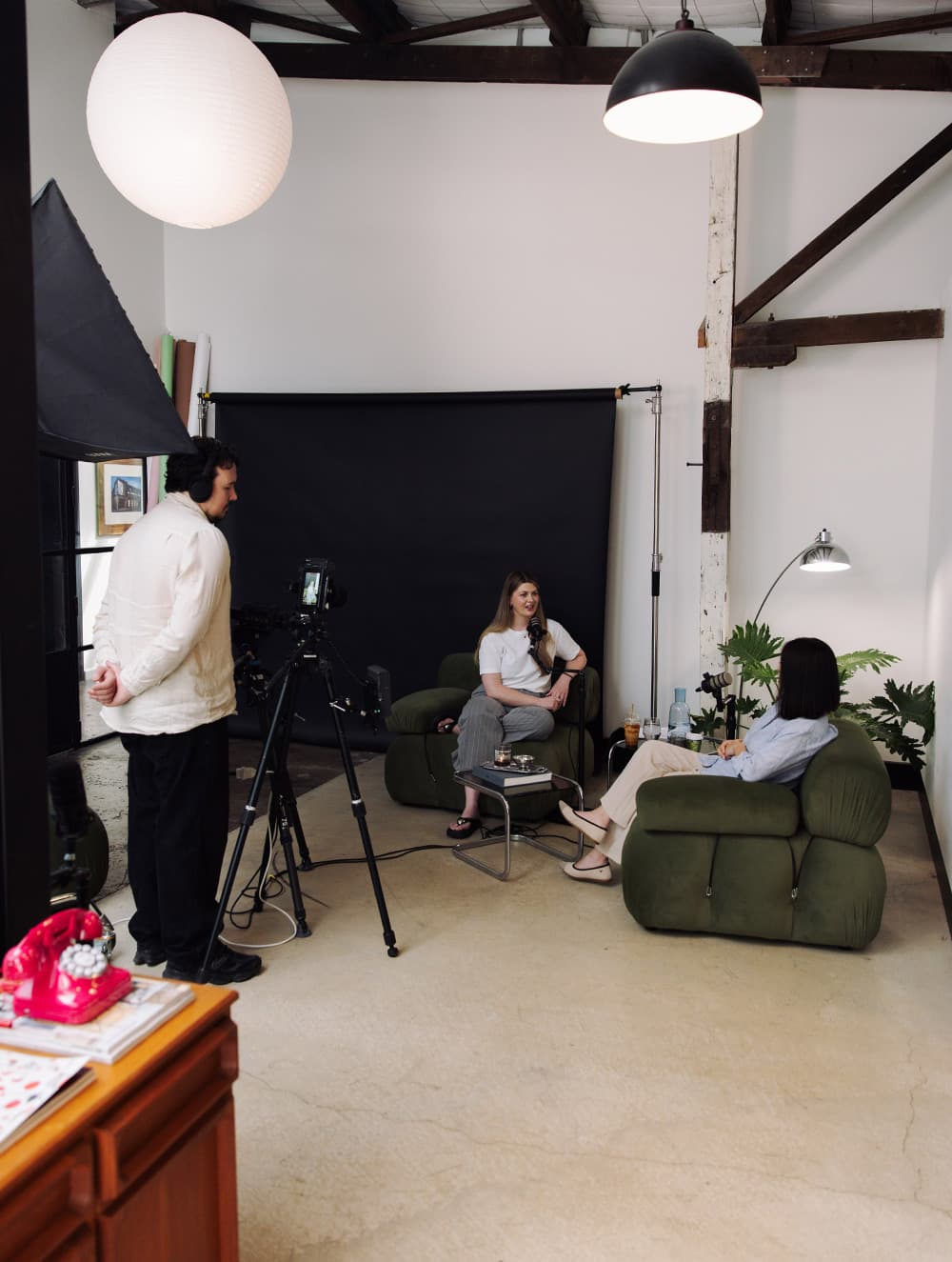 Two people in conversation in the Lucky Boy studio in Collingwood.