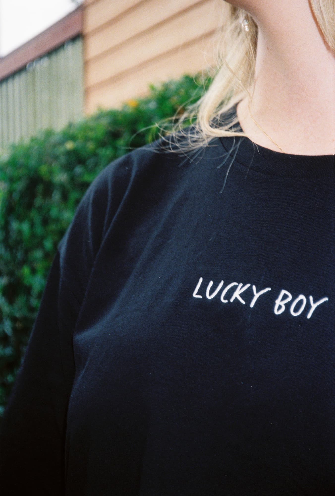 Lucky Boy branded merch, embroidered wordmark on a navy crew.