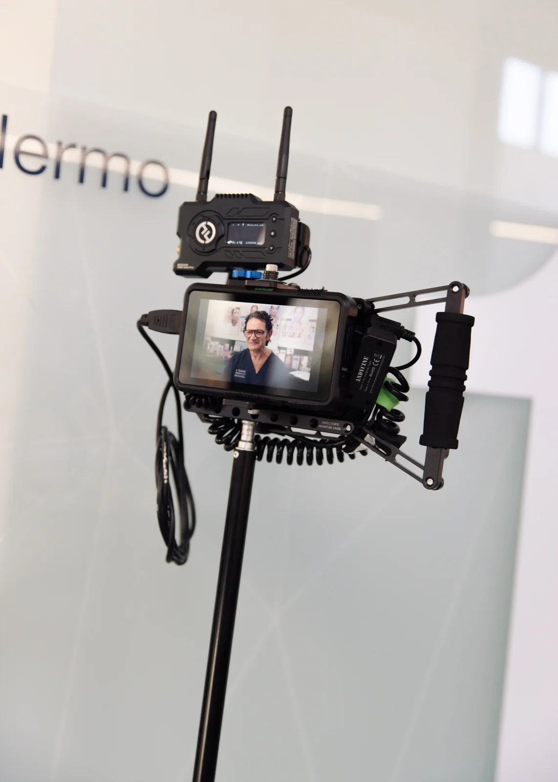 Director’s monitor showing a framed talking-head subject during recording, with the camera’s timecode and exposure overlay visible.