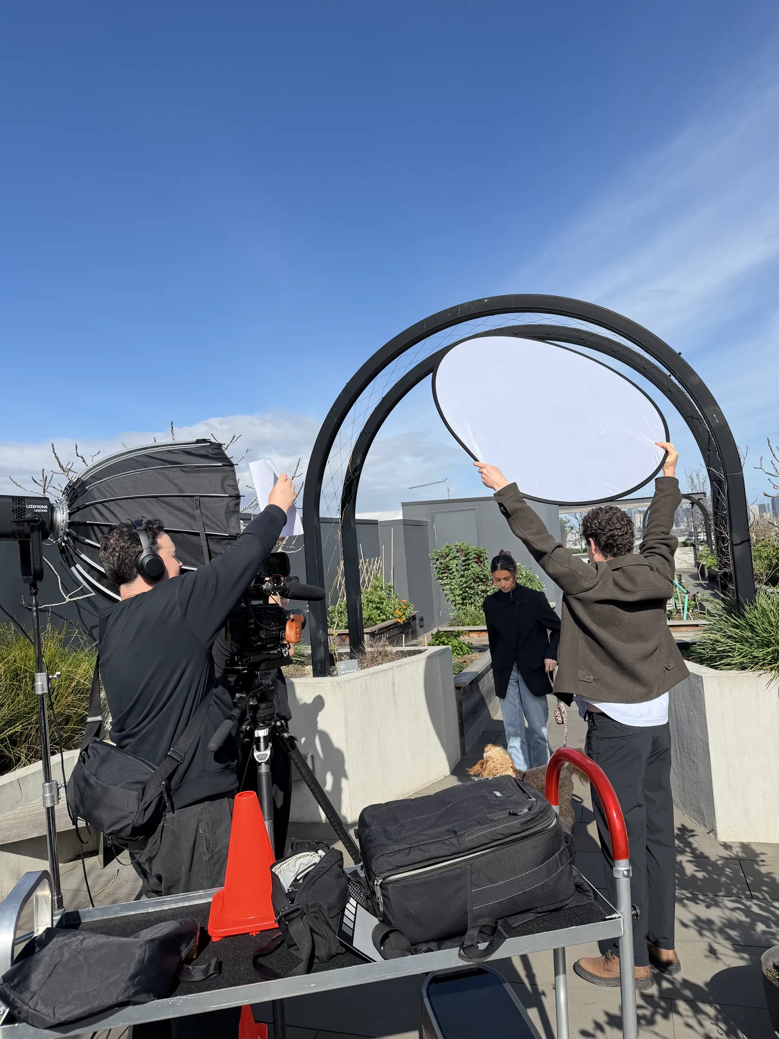 Lucky Boy crew with a camera and reflector shooting on the East Brunswick Village rooftop terrace