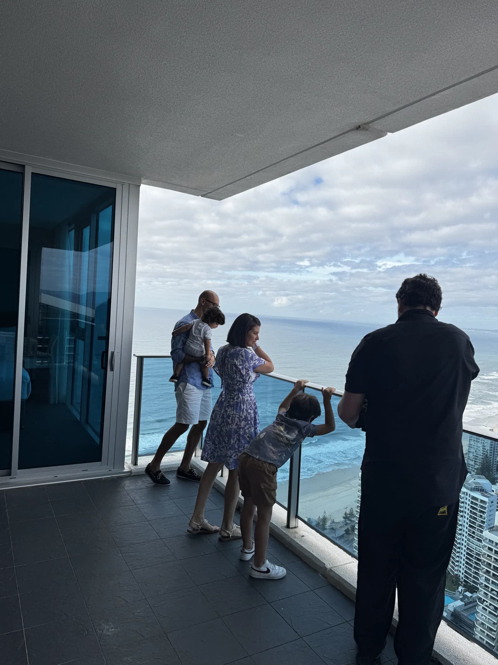 Lucky Boy crew filming a family on a Hilton Surfers Paradise residence balcony overlooking the ocean
