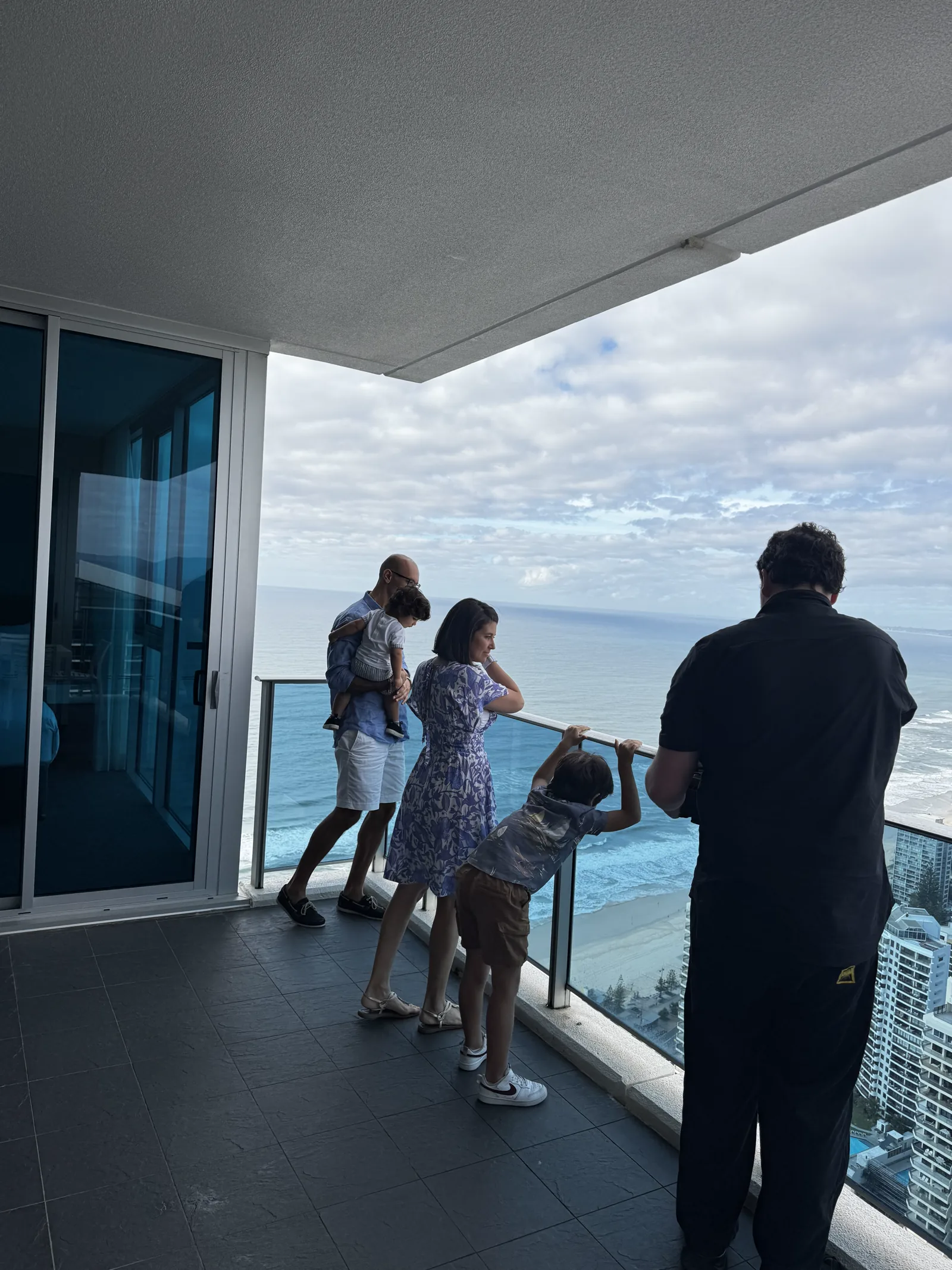 Lucky Boy crew filming a family on a Hilton Surfers Paradise residence balcony overlooking the ocean