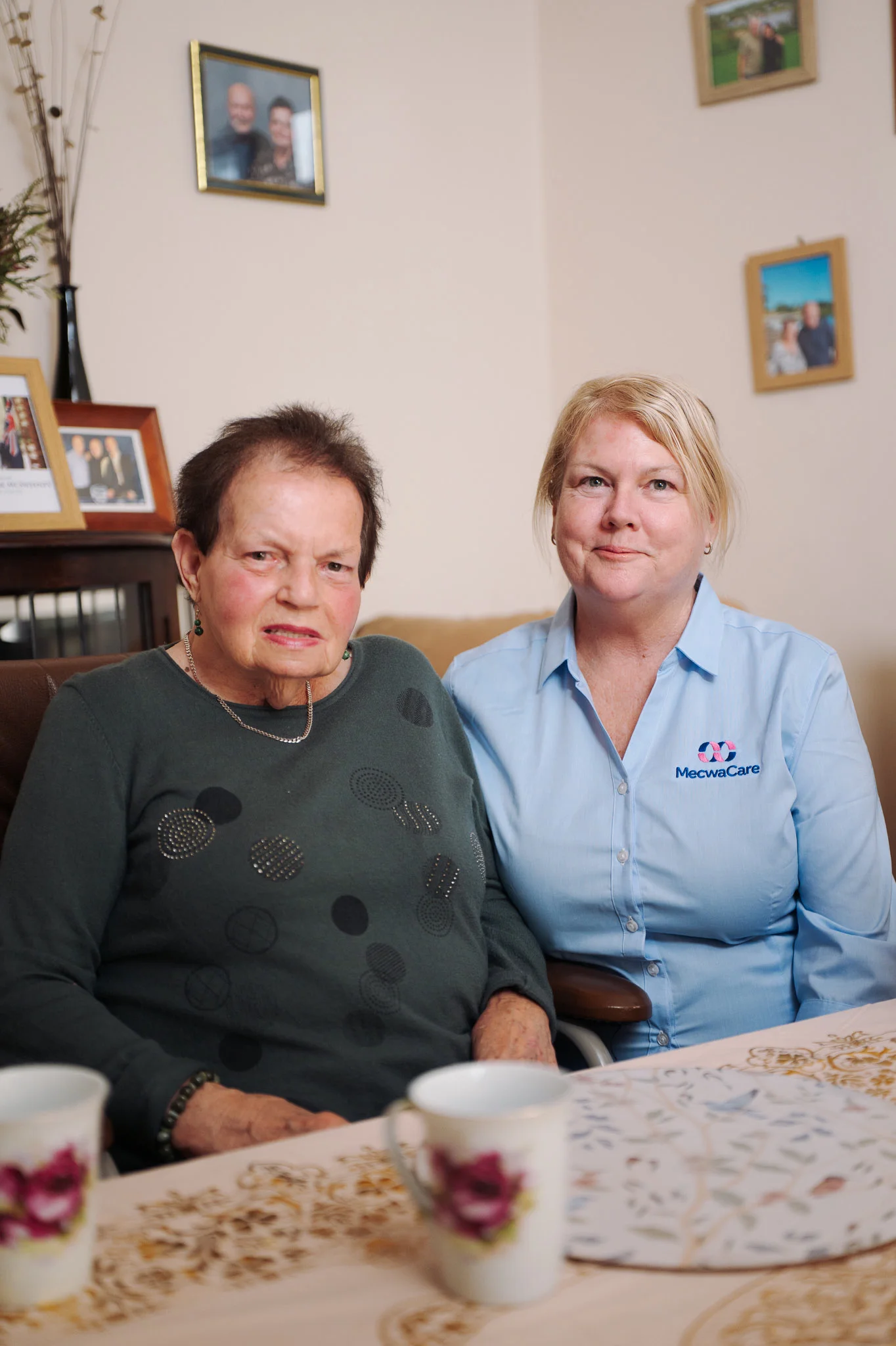 Lillian and her mecwacare carer sitting together at the dining table
