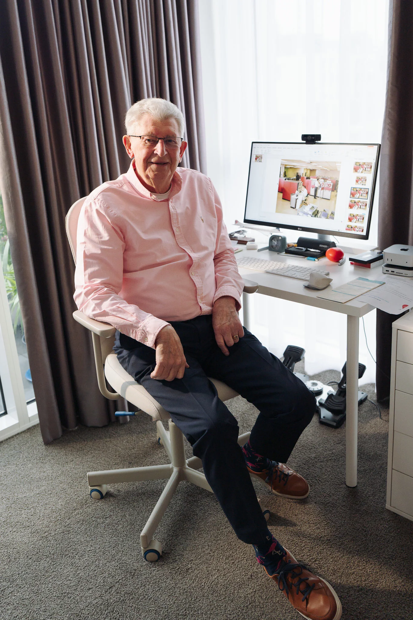 Tim at his desk and computer in his apartment at Robin Syme