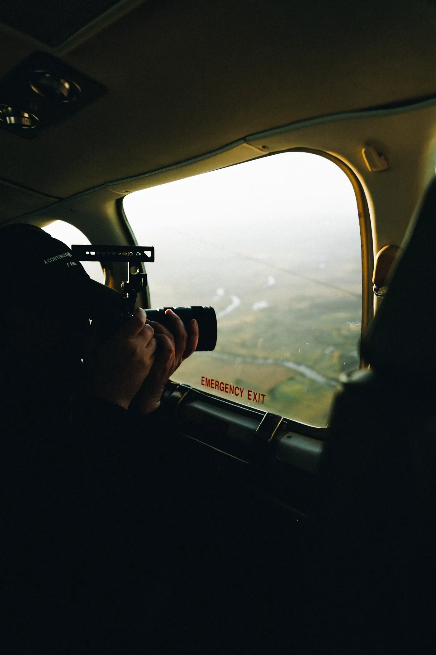 A Lucky Boy operator shooting out of the window of a light plane on the way to Moree
