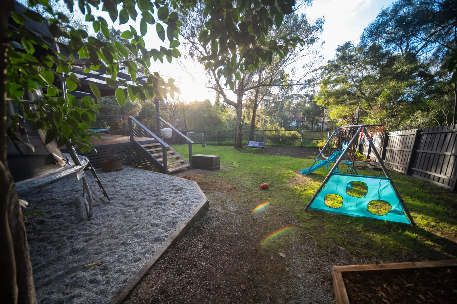 The relandscaped backyard and renovated house at the end of the St Ferrer Impact Build
