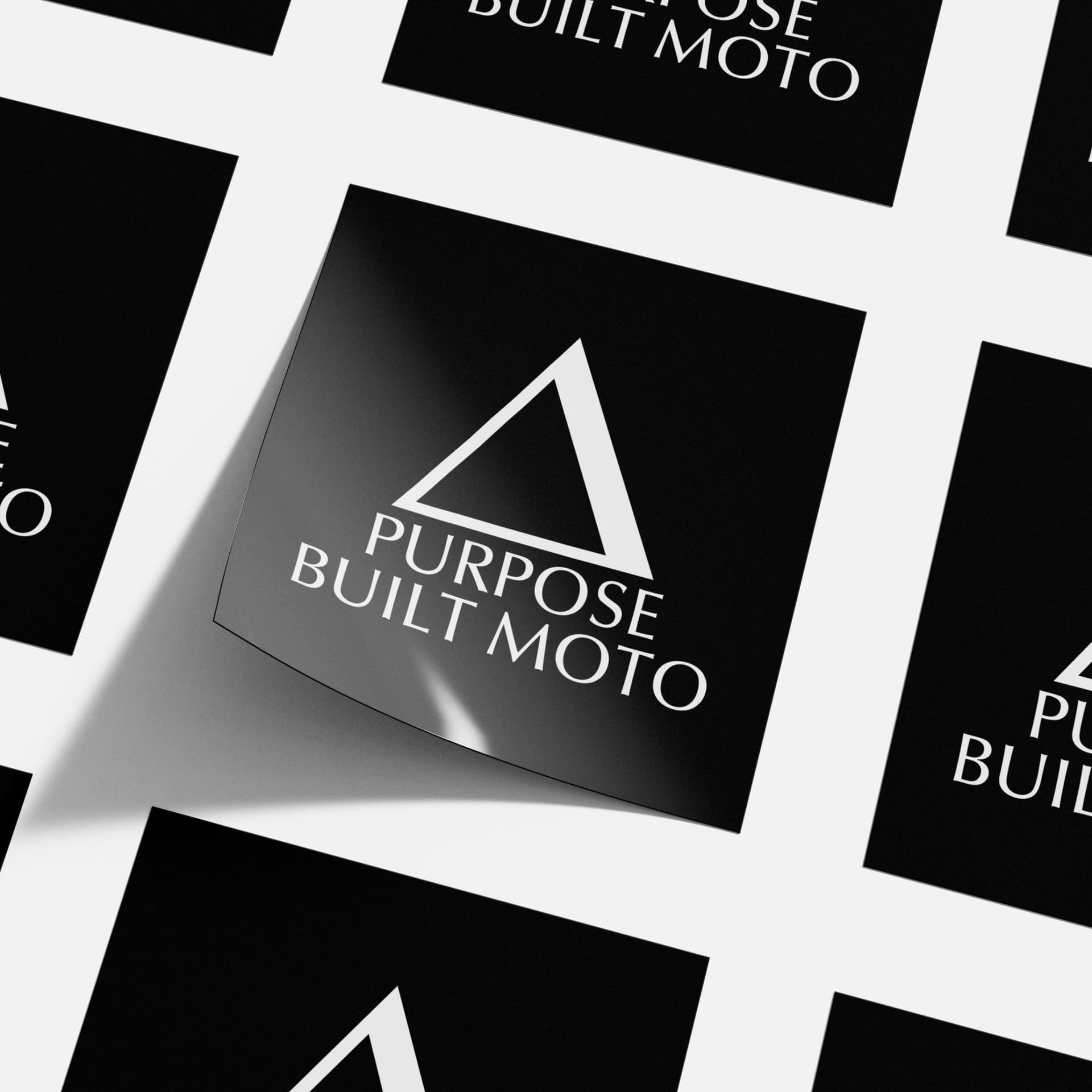 Purpose Built Moto brand identity by Lucky Boy Agency, logo applied across sticker collateral.