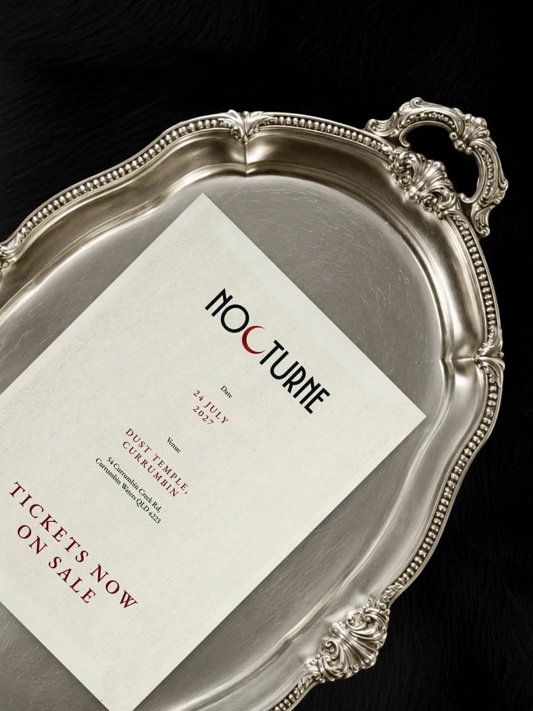 A Nocturne launch ad, the invitation on an ornate silver tray with the wordmark and event details.